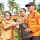 Kadis PUPR Barsel Ita Minarni menyerahkan bingkisan kepada pegawai BPBD saat apel besar usai Idul Fitri 1446 H di halaman Kantor Bupati Barito Selatan.