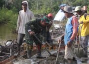 bergotong royong mengaduk semen Sinergi Warga dan Satgas TMMD Percepat Pembangunan Jalan Rabat Beton di Desa Talio